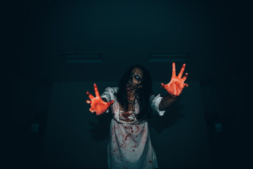 Portrait of asian woman make up ghost face with blood,Horror scene,Scary background,Halloween...