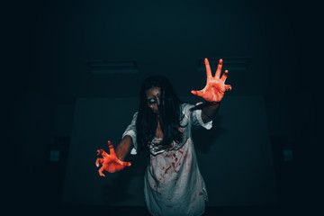Portrait of asian woman make up ghost face with blood,Horror scene,Scary background,Halloween...