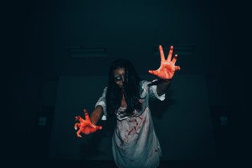 Portrait of asian woman make up ghost face with blood,Horror scene,Scary background,Halloween poster,Thailand people © reewungjunerr