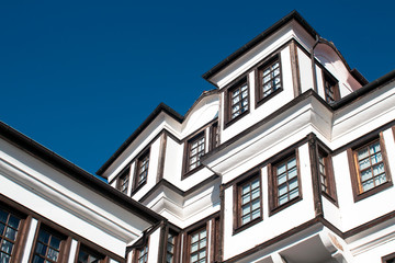 Fototapeta na wymiar The Architecture of Ohrid. Part of a beautiful old-style house on the background of the blue sky in the Old Town. Macedonia