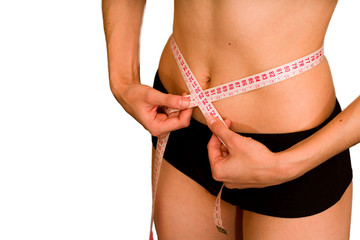 The girl measures her waist. The concept of losing weight and diet. Healthy lifestyle