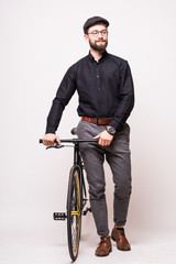 Fototapeta na wymiar Portrait of a bearded handsome young man walking with fixie monospeed bicycle over white background