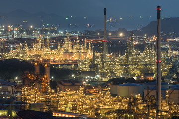 Aerial view oil storage tank with oil refinery background, Oil refinery plant at night.