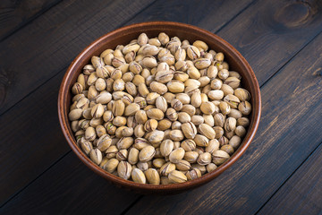Pistachios in a clay bowl.