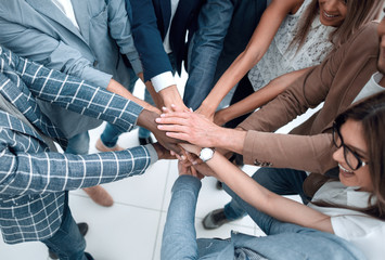 close up.Business people holding hands in a circle