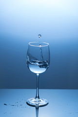 Water splash out of a wine glass.