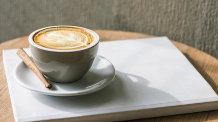 I often read the morning book with my favorite cup of coffee. Cup of Coffee latte' art with a book in Coffee shop. Noise, Retro, Vintage