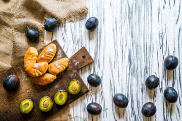 pies, plums on a white wooden background 3