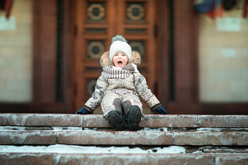 boy sitting on the stairs of the house