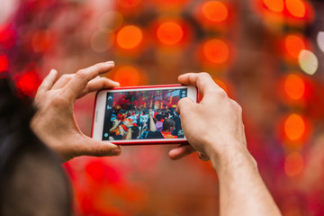 Man taking pictures on his phone performance artists. Chinese new year.