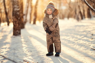 boy standing in the snowy park