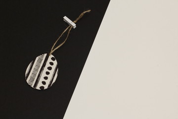 Egg decorated with napkin for decoupage on jute cord with clothespin on contrasting white and black...