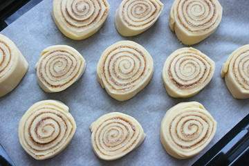 Beautiful fresh cinnamon rolls. The cooking process. Fresh fragrant pastries. Raw dough for buns.Close up.