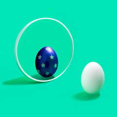 White egg with decorated reflection in mirror. Easter concept