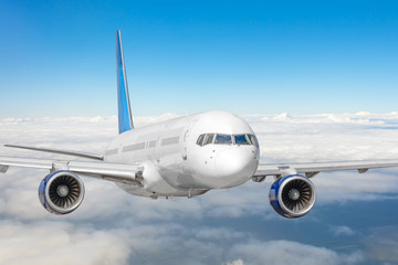 Fototapeta premium Passenger jet plane in the blue sky. Aircraft flying high through the cumulus clouds. Close up view airplane in flight