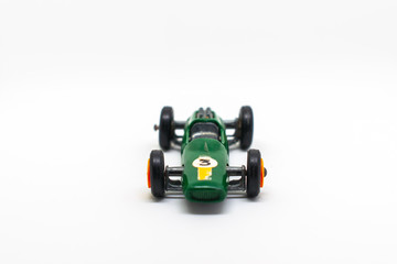 Miniature green race car with number 3 isolated on a white background for on a three-year-old birthday cart