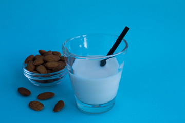 Almond milk  in the glass  on the blue  background