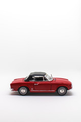 Miniature antique vintage model car isolated on a white background