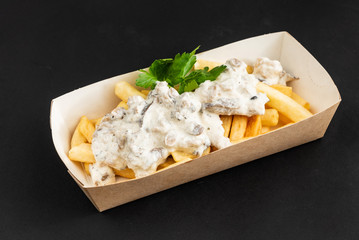 french fries  with sauce in the box