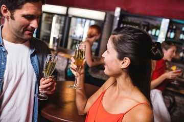Couple enjoying champagne in nightclub