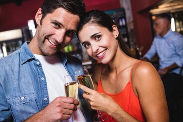 Couple enjoying champagne in nightclub