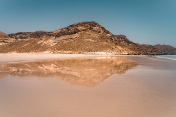Fototapeta na wymiar sand beach with a mountain on the background