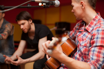 a rock band is working in studio. practice pause