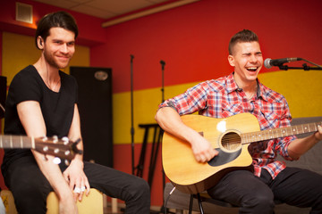 a rock band is working in studio. practice pause