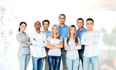 Smiling young business people on office background