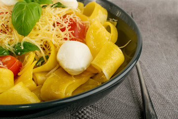Yellow italian pasta pappardelle, fettuccine or tagliatelle