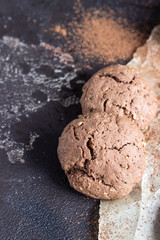 Delicious chocolate cookies with nuts on dark old concrete table. Copy space.