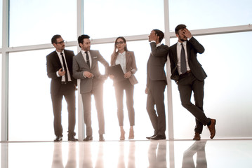 Businessmen standing next to a window