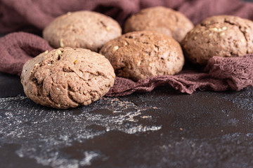 Delicious chocolate cookies with nuts on dark old concrete table. Copy space.