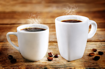 Cup of hot black coffee with coffee beans