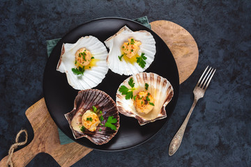 Seared scallops shell with butter, garlic and parsley.