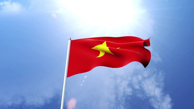 The national flag of Vietnam waving in the wind on a sunny day.  Beautiful slow motion shot of the Vietnamese flag.