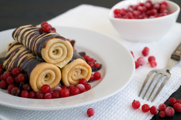 pancakes twisted with berries and chocolate sauce