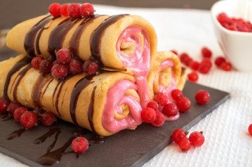 pancakes twisted with berries and chocolate sauce