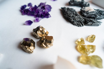 Collection of beautiful precious stones on white table.