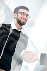 Fototapeta premium from behind the glass.handshake business people