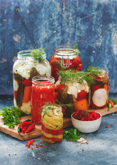 Homemade Pickles Of Different Vegetables In Jars On Rustic Table, selective focus