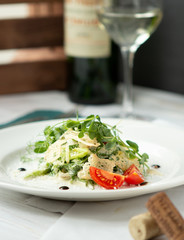 vegetarian green salad with croutons, glass of wine in the background