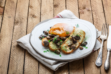 Creamy egg with bread and mushrooms on a plate