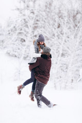 Fototapeta na wymiar Young couple in love outdoor snowy winter
