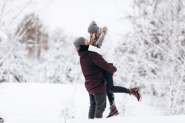 Young couple in love outdoor snowy winter