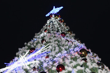 Christmas tree decorated with garland and red balls