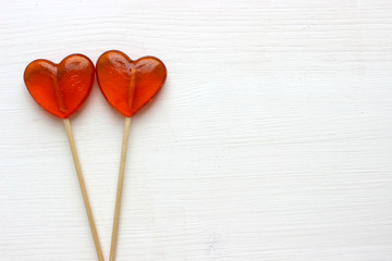 Romantic Valentine's day background. Lollipops in the shape of heart close up isolated on white background. Copy space.