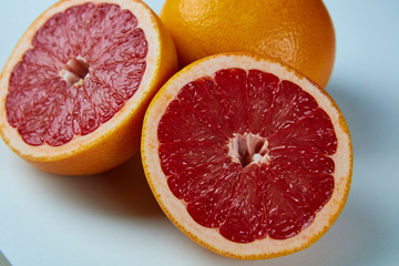 Line of sliced red grapefruit flat lay and top view. Macro photo of citrus fruits isolated on white black 