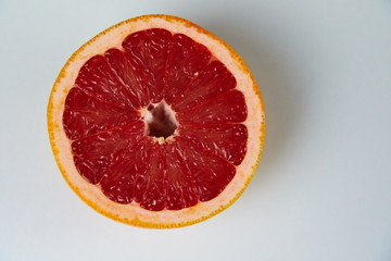 Line of sliced red grapefruit flat lay and top view. Macro photo of citrus fruits isolated on white black 