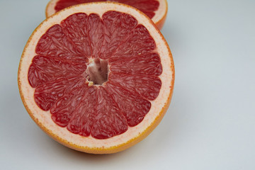 Line of sliced red grapefruit flat lay and top view. Macro photo of citrus fruits isolated on white...
